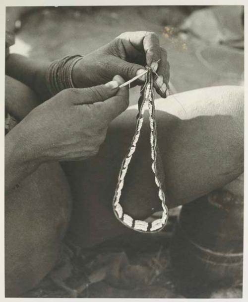 Woman's hands sewing headband together, close-up


























