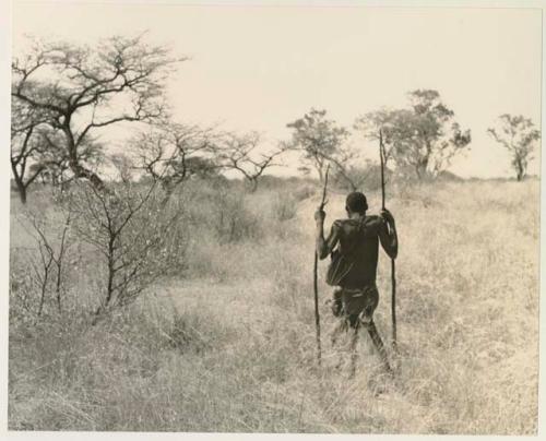 !Kham using sticks as crutches and walking with his son























