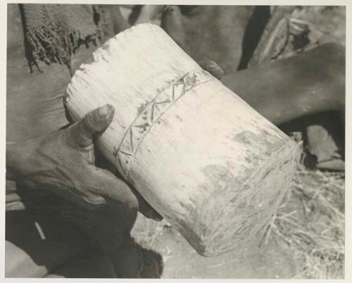 Person's hands holding a mortar, close-up


























