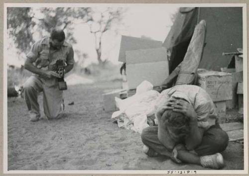 Robert Story taking a picture of Elizabeth Marshall Thomas bent over, hiding her face
























