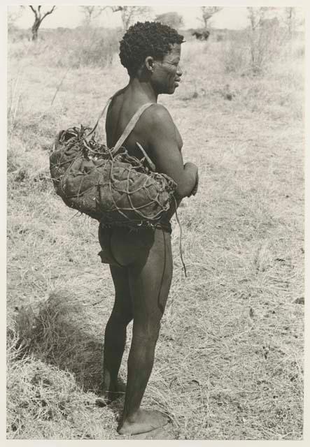 Back view of ≠Toma, with a net on his back
























