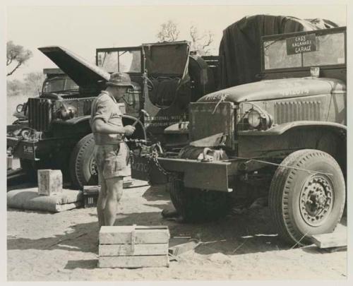 Casper Kruger standing beside the two GMC trucks























