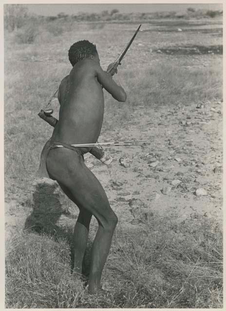 "Crooked /Qui" demonstrating shooting an arrow, seen from the back
























