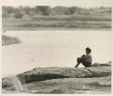 Elizabeth Marshall Thomas sitting beside the water








