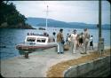 Soldiers standing on dock next to crash-boat