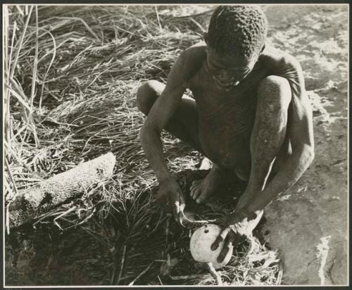 "Waterhole / Gwia": "Old /Gaishay" of Band 4 filling his ostrich eggshell with water (print is a cropped image)