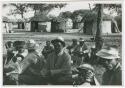 [No folder title]: Group of men sitting, watching dancing (print is a cropped image)