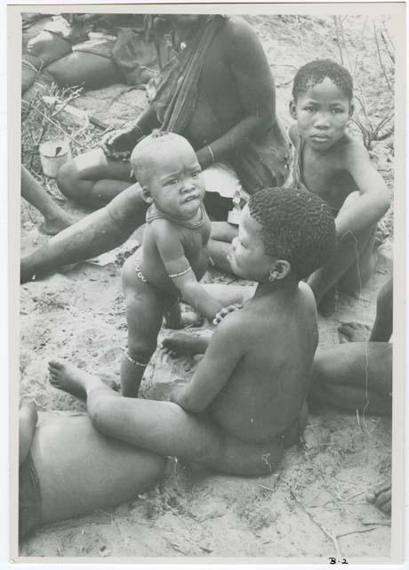 [No folder title]: Group of children sitting, close-up view (print is a cropped image)