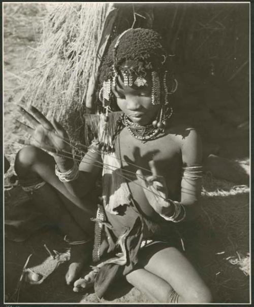 "Cats cradle": Girl holding a "cat's cradle" (print is a cropped image)