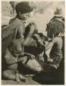 "Grooming & haircuts": //Khuana looking for lice on her child's head, N!ai looking for lice in the child's beads, and /Gaishay (son of Gao and Di!ai) examining a //guashi (print is a cropped image)