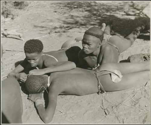 "Grooming & haircuts": "≠Gao Lame" delousing another boy and Tsamgao lying on the ground next to them (print is a cropped image)