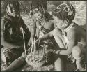 "Music": Three girls playing the //guashi (print is a cropped image)