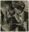 "Music": Two girls playing the //guashi (print is a cropped image)