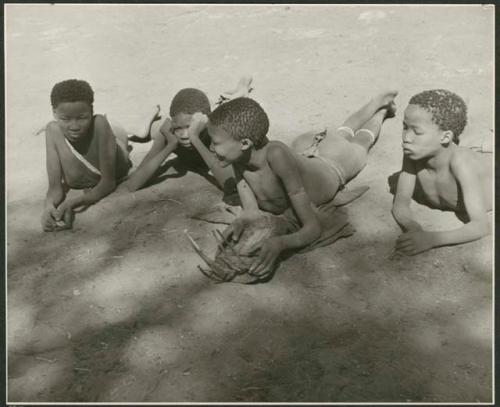 "Music": ≠Toma (son of Gau) playing the //guashi, with "≠Gao Lame," an unidentified boy and Tsamgao listening to him (print is a cropped image)