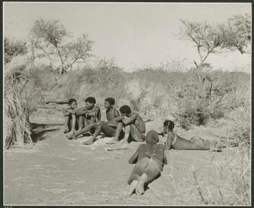 "Music": "/Gao Music" playing the //guashi, with //Ao and others singing and "≠Gao Lame" lying down (print is a cropped image)