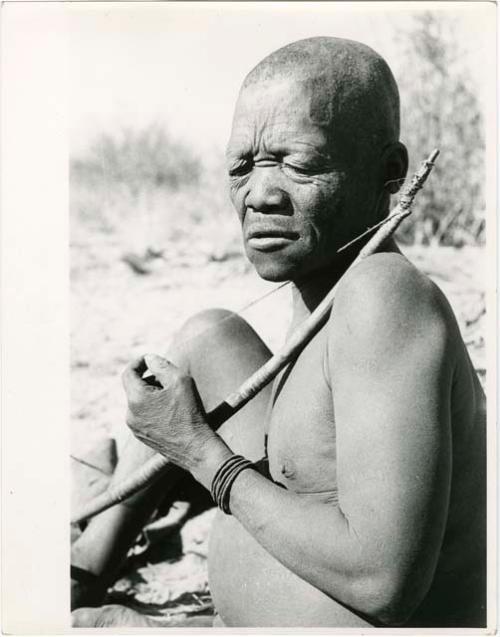 "Music": Close-up of Oukwane seated, playing a bow (print is a cropped image)