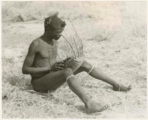 "Music": "/Gao Music" sitting and playing the //guashi (print is a cropped image)