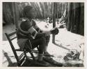 "Moremi's wife & a cow": Makiena (Muremi's wife) sitting in her kraal, wearing her Kwangali beads and copper anklets (print is a cropped image)