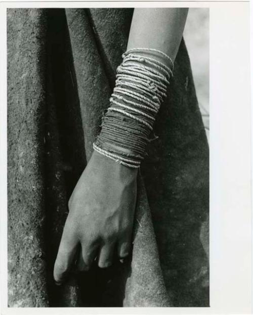 "Ornaments": Lower arm bracelets worn by Ju/'hoan women, including a number of wound grass bracelets and many made of vegetable fiber cord (print is a cropped image)