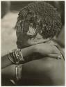 "Ornaments & beads": //Kushay (wife of "/Qui Navel", Band 1) leaning her head on her arm (print is a cropped image)