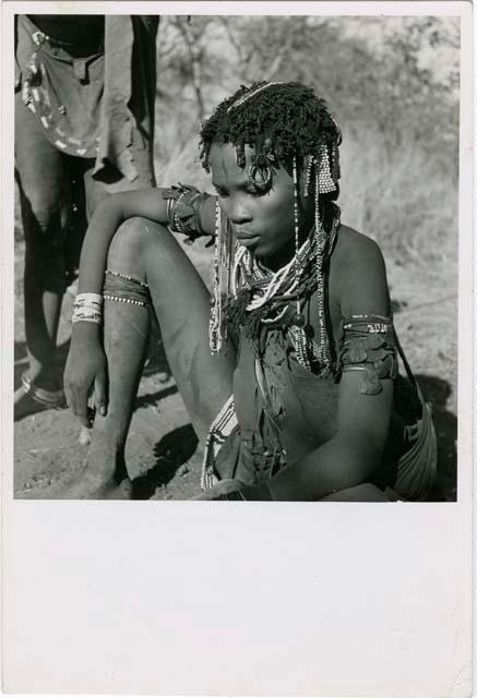 "Ornaments & beads": Woman from /Ti!kay's group sitting (print is a cropped image)