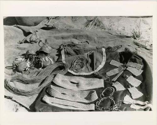 "Ornaments & beads": Woman's ornaments displayed on a kaross (print is a cropped image)