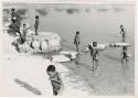 "Pan": Children playing in the water and people on the shore (print is a cropped image)