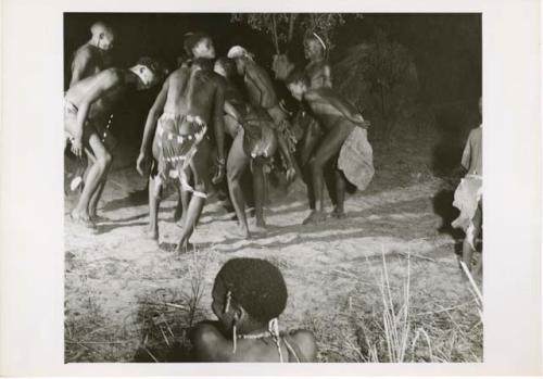 [No folder title]: Men and boys dance in a tight group in a night dance (print is a cropped image)