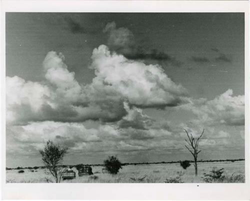 [No folder title]: Two trucks crossing the plain (print is a cropped image)