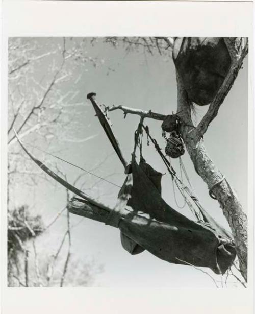 "Possessions": Hunting bag, knife, and other possessions hung in a tree (print is a cropped image)