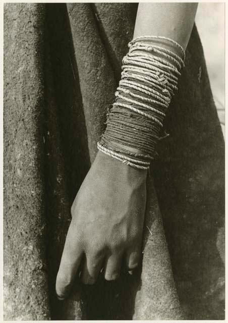 "Ornaments": Lower arm bracelets worn by Ju/'hoan women, including a number of wound grass bracelets and many made of vegetable fiber cord (print is a cropped image)