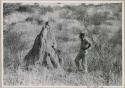 Daniel Blitz standing next to a large termite mound