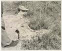 Casper Kruger standing next to a pits and a rock formation near the Herero Reservation, close-up