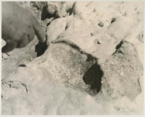 Casper Kruger standing next to a pits and a rock formation near the Herero Reservation, close-up