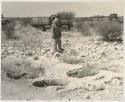 Laurence Marshall standing next to pits and expedition trucks