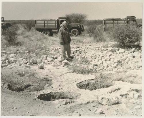 Laurence Marshall standing next to pits and expedition trucks