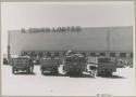 Expedition trucks parked in front of a building