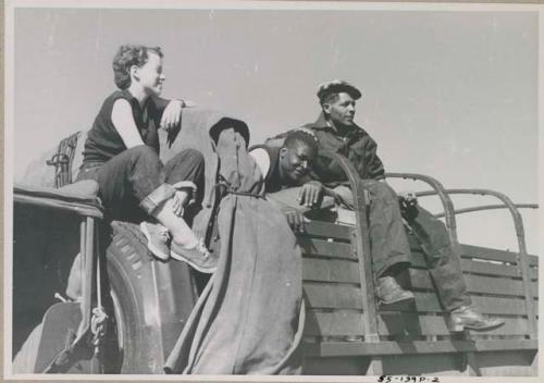 Philip Hameva, Heinrich Neumann and Elizabeth Marshall Thomas sitting on the top of an expedition truck