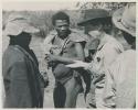 Group of people receiving tobacco from Lorna Marshall