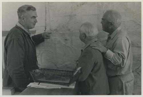 Ernest Midgely, District Commissioner of Ghanzi in his office, with L. F. Maingard and Laurence Marshall