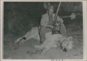 Theunis Berger sitting over a dead lion, holding a gun