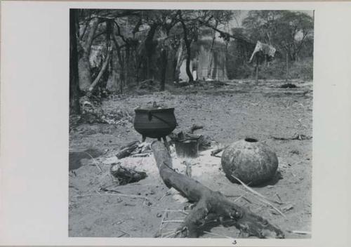 Cooking fire, with huts in background