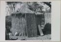 Fence-type hut with roof and door in place
