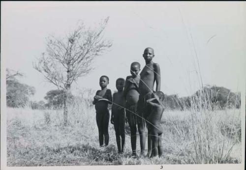 Group of children standing near Muzwamo River
