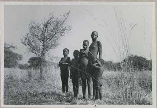 Group of children standing near Muzwamo River
