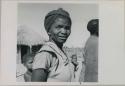 Woman standing, close-up, with children behind her