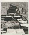 Top of expedition GMC, with trucks behind in a line; Lorna Marshall and Laurence Marshall standing beside trucks






















