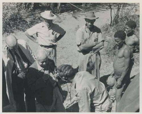 Group of people talking with L. F. Maingard, preparation for a recording