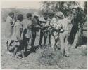 Group of people receiving tobacco from Lorna Marshall