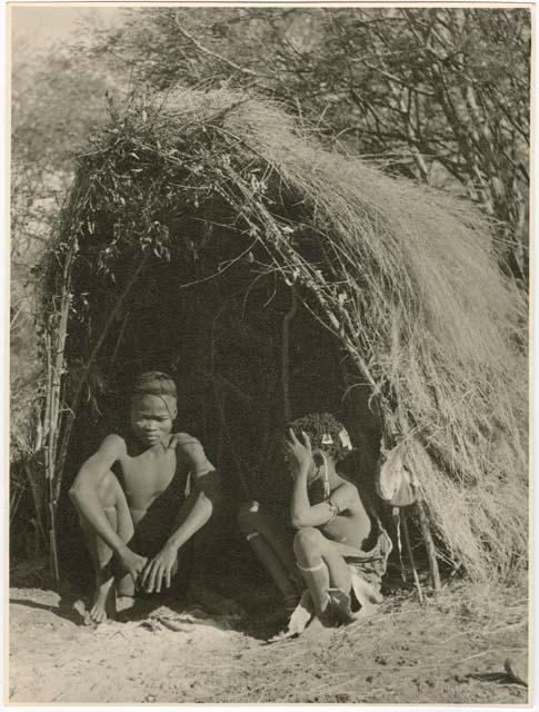 "Living places, shelters": Tsamgao and Bau sitting in front of their skerm (print is a cropped image)